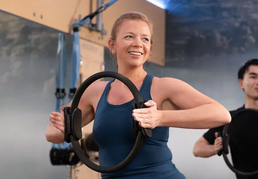 Member smiling during a Reformer class